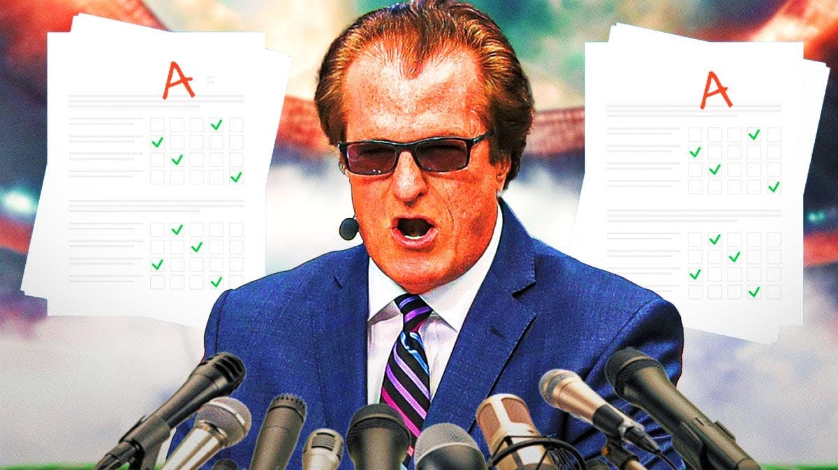 Mel Kiper Jr. in front of two papers with A grades.