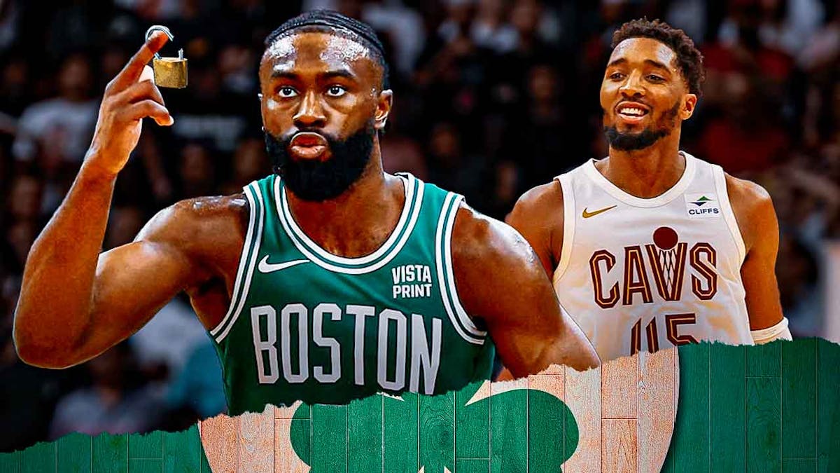 Celtics' Jaylen Brown holding huge broken padlocks, with Cavs' Donovan Mitchell smiling